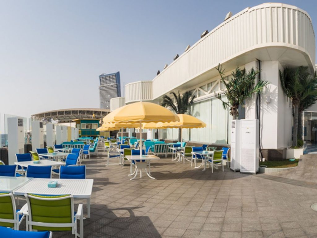 Family-friendly restaurants in Jeddah: Blue Ocean patio with yellow umbrellas